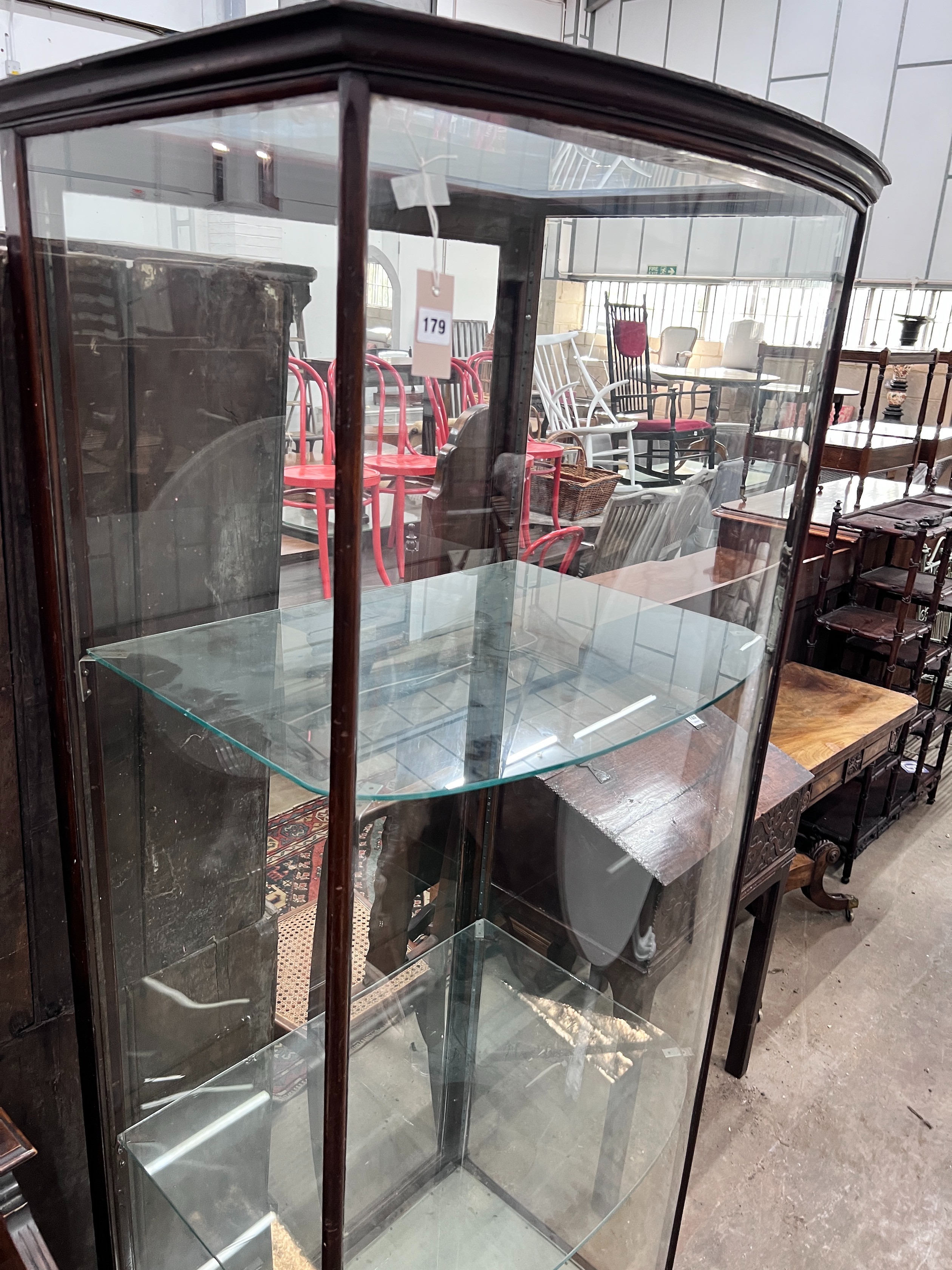 A late Victorian mahogany bowfront shop display cabinet, width 84cm, depth 58cm, height 196cm *Please note the sale commences at 9am.